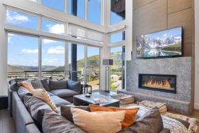 Modern home with three balconies, mountain views, and outdoor swimming pool. Walk to hiking trails